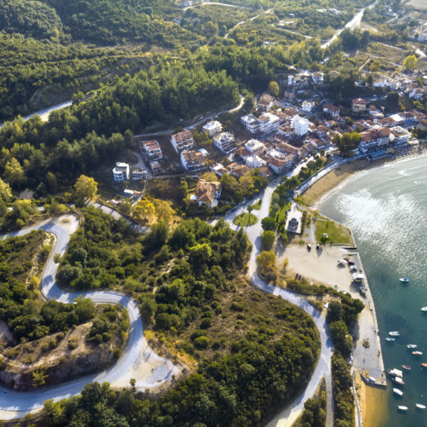 Aerial drone view of blue sea and windy mountain roads in Halkidiki, Greece